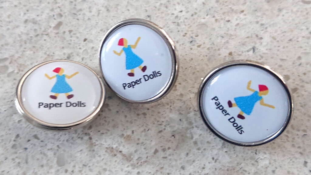'Paper Dolls' pin badges